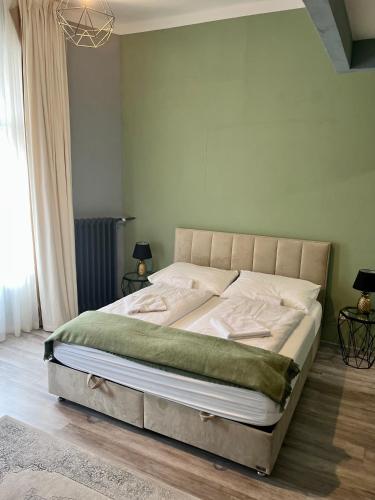 a bedroom with a large bed in a room at W Urban Suites Budapest in Budapest