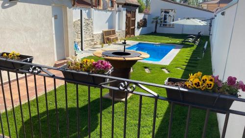 a balcony with a garden and a swimming pool at LA ANTIGUA TABERNA in Nieva
