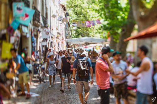 a crowd of people walking down a city street at Les Précieuses Suites & Spa I in Avignon