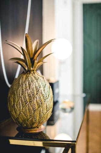 a pineapple sitting on top of a table at Les Précieuses Suites & Spa I in Avignon