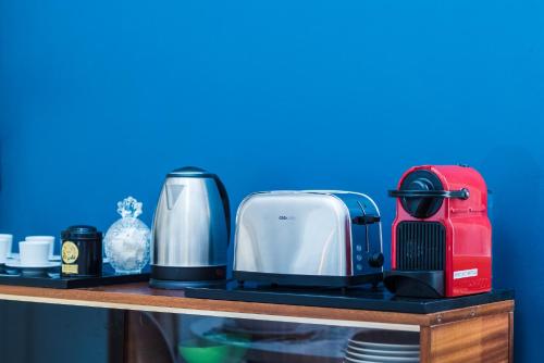 a toaster and coffee maker on a shelf at Les Précieuses Suites & Spa I in Avignon