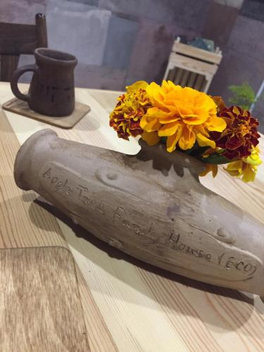 a vase of flowers sitting on top of a table at Apple Tree Family Home (ECO) in Dzorakap