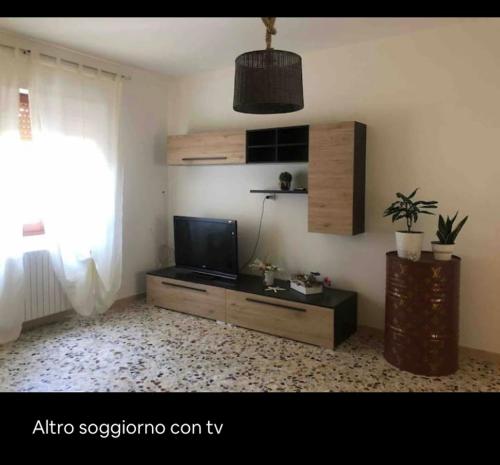 a living room with a flat screen tv and a window at Azienda agricola Villa Giorgio in Torino di Sangro