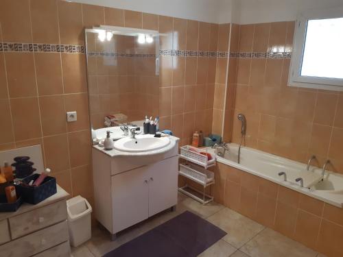 a bathroom with a sink and a bath tub at Villa Maison Cévennes et Sud Ardèche in Bessèges