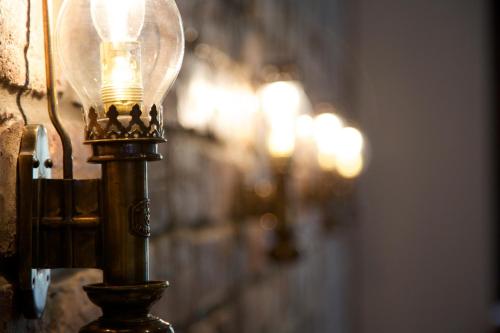a light on a wall with a bunch of lights at The Z Hotel Glasgow in Glasgow