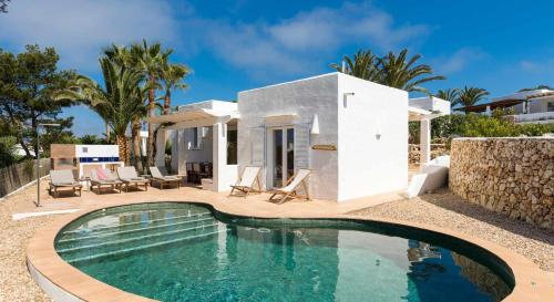 a swimming pool in front of a villa at Villas Etnia in Binissafuller