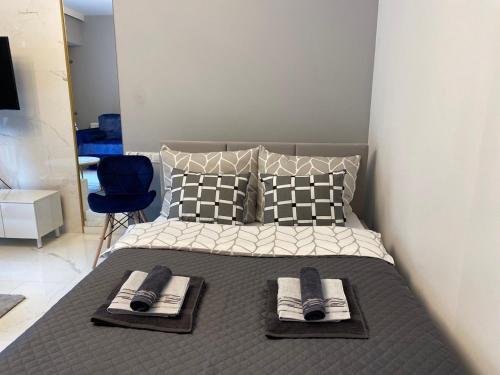 a bedroom with a bed with towels on it at Apartament Angel City SPA Silownia in Wrocław