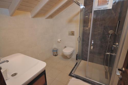 a bathroom with a shower and a toilet and a sink at Brothers Cesme Hotel in Cesme