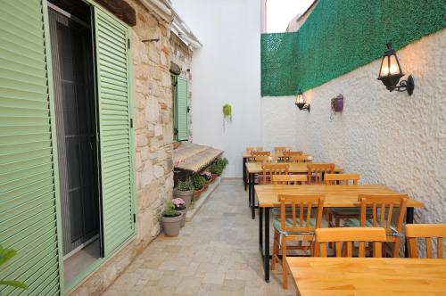 a row of tables and chairs in a restaurant at Brothers Cesme Hotel in Cesme