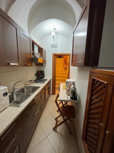 a kitchen with a sink and a counter top at Bellini Holiday Home - Appartamento con balcone NAPOLI in Naples