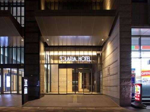 a building with a sign on the front of it at Solaria Nishitetsu Hotel Kagoshima in Kagoshima