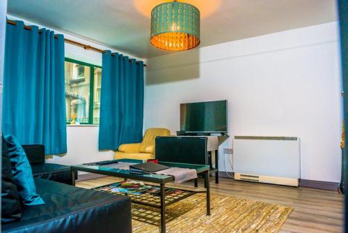 a living room with a couch and a table at 1 bedroom apartment by Trinity in Dublin