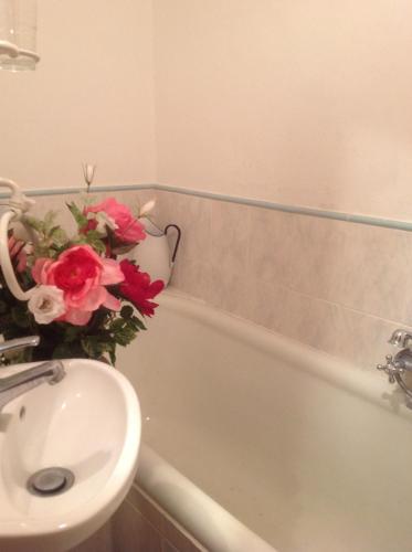a bathroom with a sink and a vase of flowers at Il Broglino in Todi