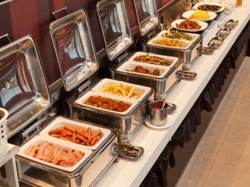 a buffet line with many trays of food on at Solaria Nishitetsu Hotel Kagoshima in Kagoshima