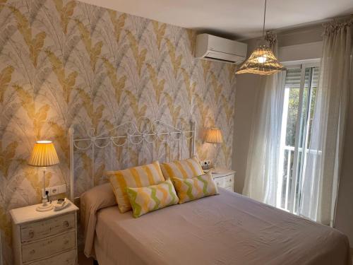 a bedroom with a bed with two pillows on it at Velilla Apartment “Sun&Sea” in Almuñécar