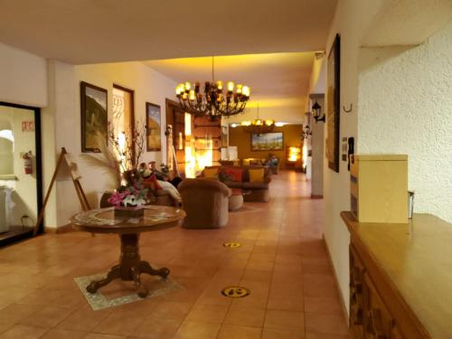 a living room with a couch and a table at HOTEL MISION SANTA MARIA in San Quintín