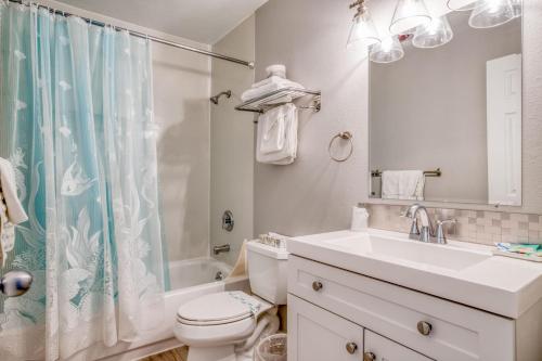 a bathroom with a sink and a toilet and a shower at Beach Captain - Meredith Lodging in Neskowin