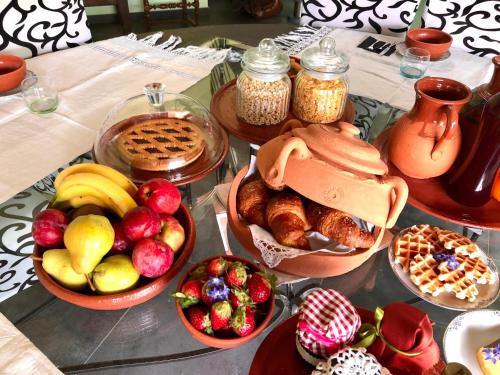 a table topped with bowls of fruit and other foods at Il Vecchio Comune B&B in Cintano