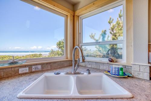 a kitchen with a sink and two windows at Sea-Esta in Tierra Del Mar - Meredith Lodging in Tierra Del Mar