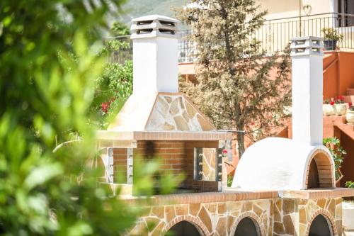 a house with a chimney on top of a building at Therianos Traditional Villas in Kallithea