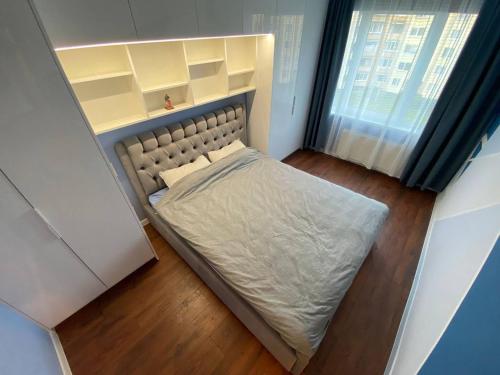 małe łóżko w małym pokoju z oknem w obiekcie BLUE SKY APARTMENT w Jurmale