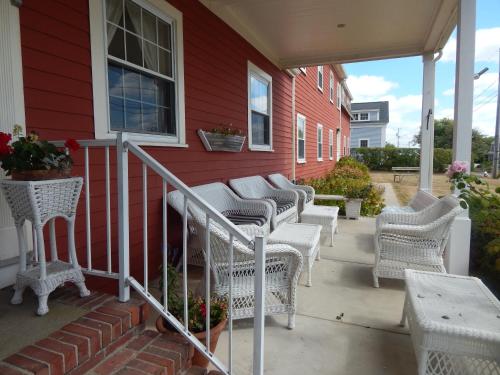 a row of wicker chairs on a house at Surfside Inn Chatham in Chatham