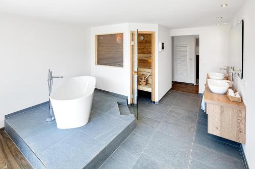 a bathroom with two sinks and two toilets at Hotel Kühberg in Oberstdorf