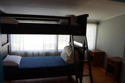 a bunk bed in a room with a window at Sea View Motel in Ogunquit