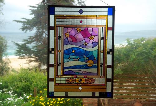 a stained glass window with a view of the ocean at Cinque Colori Bed & Breakfast- Spa in Algarrobo