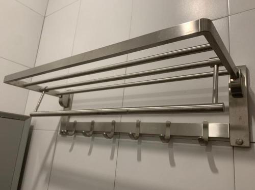 a stainless steel light fixture hanging from a wall at Kota Permai Mini Rest Room 99 Full Equipped in Bukit Mertajam