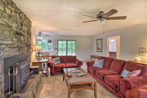 a living room with a couch and a fireplace at Norfork Getaway Walk in White River Access! in Norfork