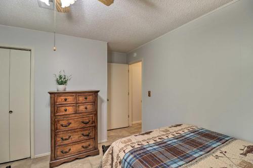 a bedroom with a bed and a dresser and a ceiling at Norfork Getaway Walk in White River Access! in Norfork