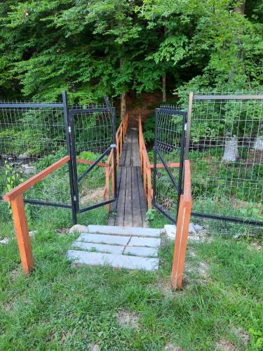 a wooden gate with steps leading through a fence at Ibis in Sovata