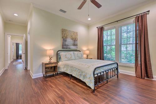 a bedroom with a bed and a large window at Lovely Mobile Retreat with Deck and Front Porch! in Mobile
