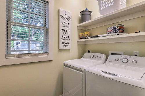 a laundry room with a washing machine and a window at Lovely Mobile Retreat with Deck and Front Porch! in Mobile