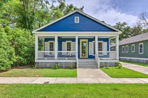 a blue and white house with a porch at Lovely Mobile Retreat with Deck and Front Porch! in Mobile