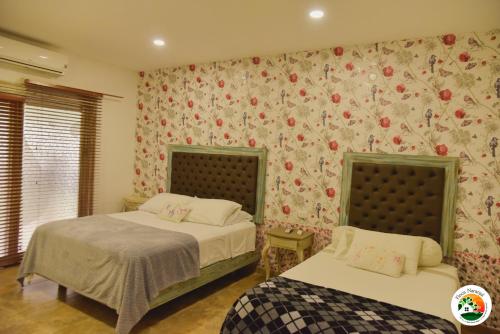 Uma cama ou camas num quarto em Hotel Finca Naranjal