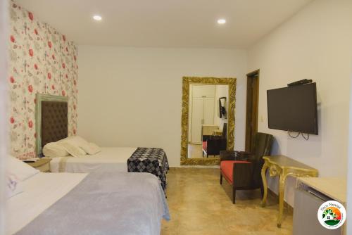 Uma cama ou camas num quarto em Hotel Finca Naranjal