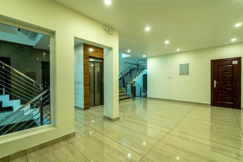 an empty hallway with stairs and a staircase at Daan Regency in Trichūr
