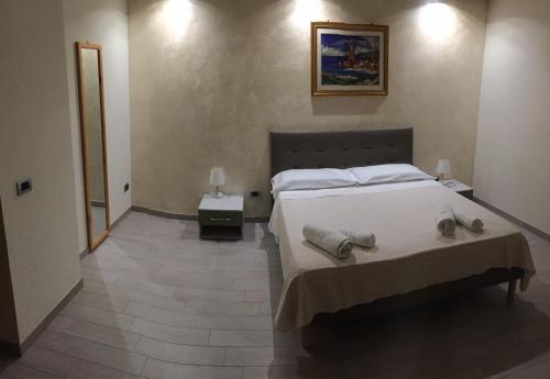a bedroom with a bed with towels on it at Belvedere Residence in Zungri