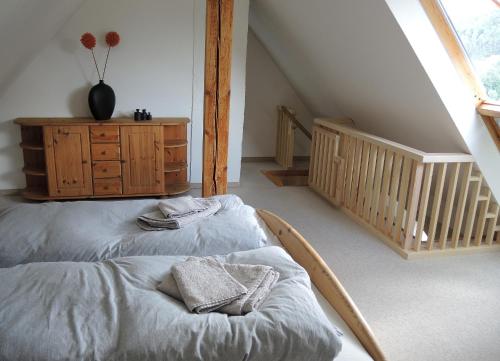 a bedroom with a bed and a dresser in a attic at Casa Karp "Maisonette" in Königstein an der Elbe