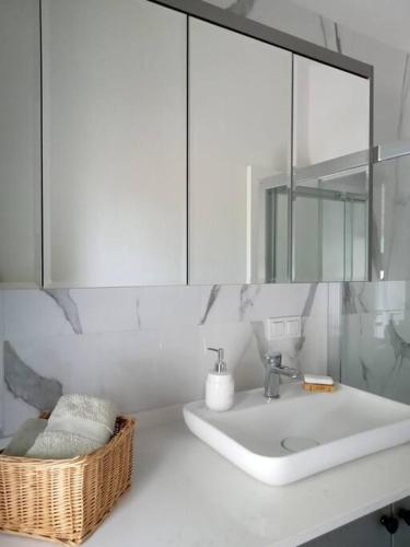 a white bathroom with a sink and a mirror at Villa Narlibahce in Ortaca