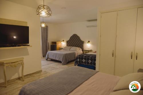 Uma cama ou camas num quarto em Hotel Finca Naranjal