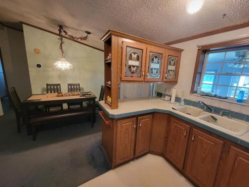 an overhead view of a kitchen with a sink and a table at Camp Not Found - 3 Queen Bedrooms by the lake in Hartstown