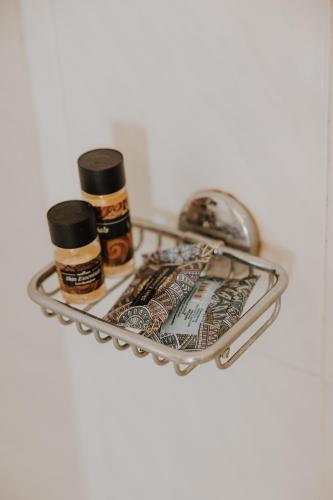 a shelf with two bottles of essential oils on it at House of Gardenia in Makrirrákhi