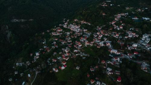 an aerial view of a village in a forest at House of Gardenia in Makrirrákhi