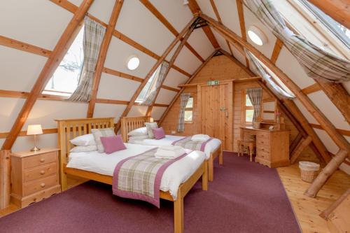 a bedroom with two beds in a attic at Rabbie Burns Lodge in Maybole
