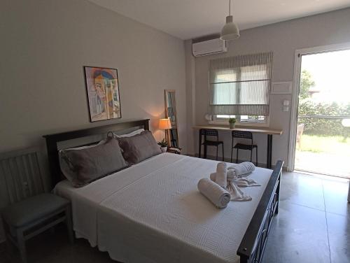 a bedroom with a large bed with towels on it at Fani House in Kallithea Halkidikis