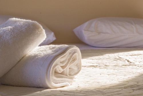 a bed with white towels on top of it at Panstel Bungalows in Kerames Rethymno in Kerames