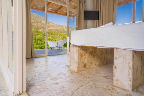 a room with a bed and a view of a mountain at Panstel Bungalows in Kerames Rethymno in Kerames
